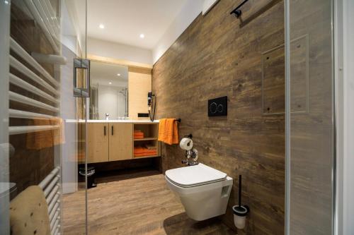 a bathroom with a toilet and a glass shower at Gasthof zum Ochsen in Vöhrenbach