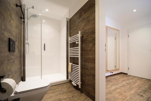 a bathroom with a toilet and a glass shower at Gasthof zum Ochsen in Vöhrenbach