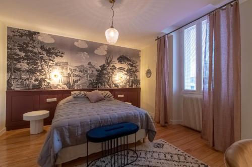 a bedroom with a bed and a large window at O Thil in Aire-sur-lʼAdour