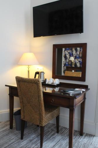 a desk in a hotel room with a chair at Best Western de Diane in Nevers