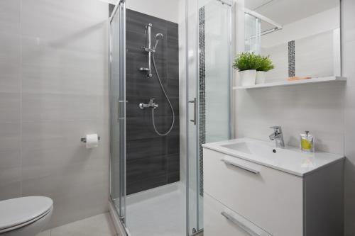 a bathroom with a shower and a toilet and a sink at Lemechi Casa Girasole Apartments in Rabac