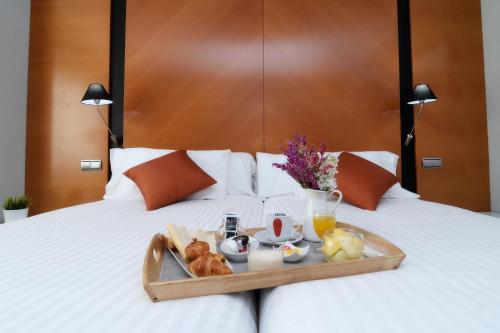 a tray of food on top of a bed at Silken Juan de Austria in Valladolid