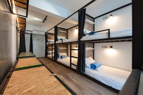 a group of bunk beds in a room at Bedbox Hostel in Athens