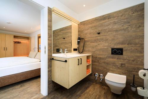 een badkamer met een bed, een wastafel en een toilet bij Gasthof zum Ochsen in Vöhrenbach