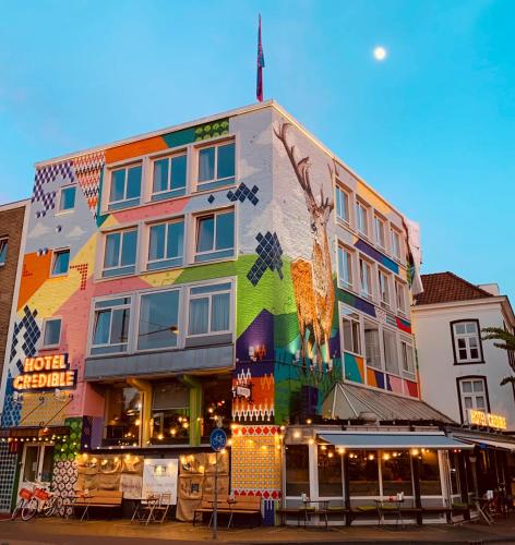 a building with a painting of a giraffe on it at Hotel Credible in Nijmegen