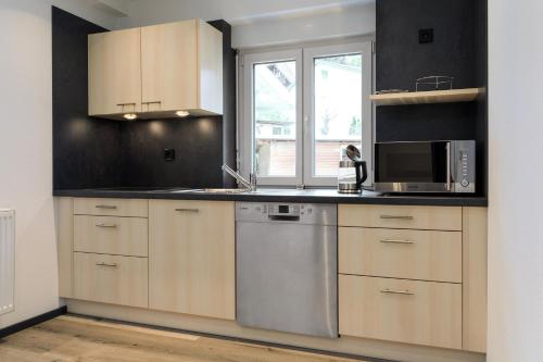 a kitchen with a sink and a microwave at Gasthof zum Ochsen in Vöhrenbach