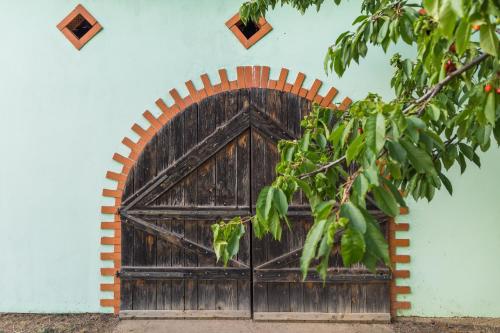 a wooden door on the side of a building at Village Wine House in Mandićevac