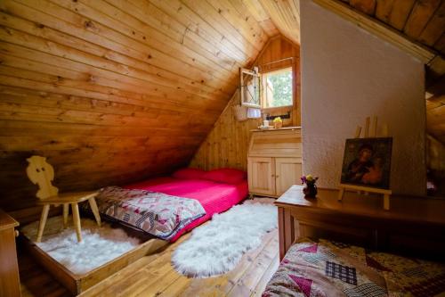 a bedroom with a bed in a wooden cabin at Chalet Pinja - I FEEL ALPS in Stahovica