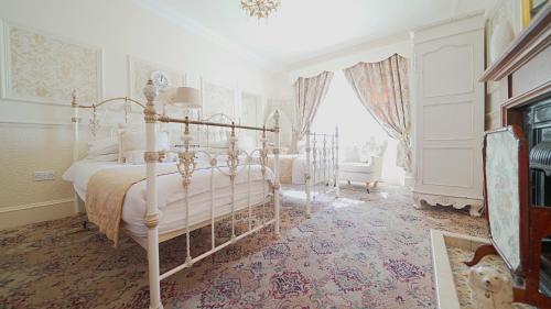 a white bedroom with a bed and a window at The Old Tramhouse Self Catering Apartments in Stirling