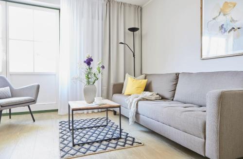 a living room with a couch and a table at Villa Fortuna in Ostseebad Sellin