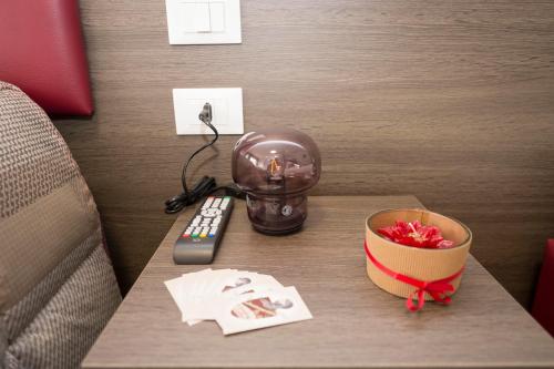 a table with a remote control and a bowl on it at B&B Il Risveglio del Cavaliere in Gioia dei Marsi
