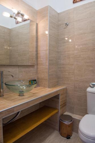 a bathroom with a sink and a toilet at Barbagiannis House in Ormos Panagias