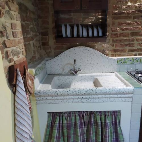 a kitchen with a sink and a counter top at Casa Giulia on Francigena in Gambassi Terme