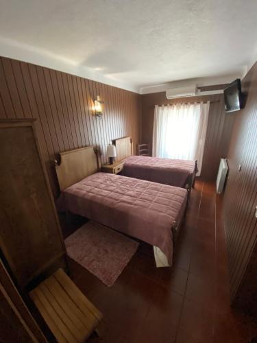 a hotel room with two beds and a window at Varanda Do Alentejo in Marvão