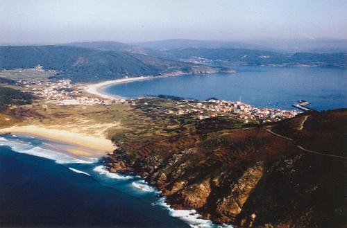 an aerial view of a beach next to the ocean at Fisterracons in Finisterre