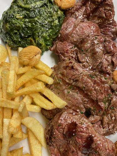 a plate of food with meat and french fries at Varanda Do Alentejo in Marvão