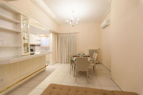 a dining room and kitchen with a table and chairs at Acropolis view and 360 degrees in Athens
