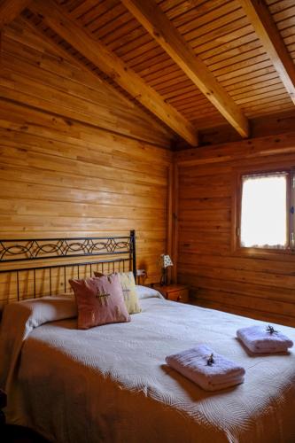 a bedroom with a bed with two towels on it at CASAS EN FINCA ECOLÓGICA LA ESPIRAL, NATURALEZA, CALMA Y VISTAS al MAR, in Icod el Alto