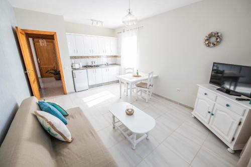 a living room with a couch and a table at Aguamarina in Tarajalejo