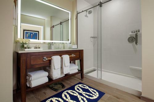 a bathroom with a sink and a shower with a mirror at Bristol Harbor Inn in Bristol