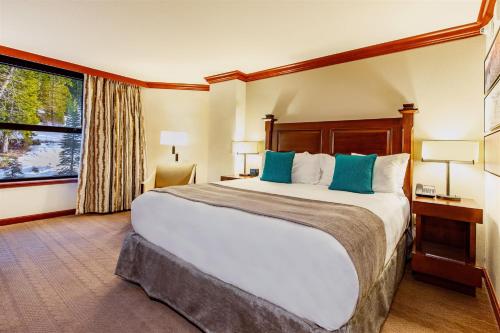 a hotel room with a large bed and a window at Everline Resort and Spa, Lake Tahoe in Olympic Valley