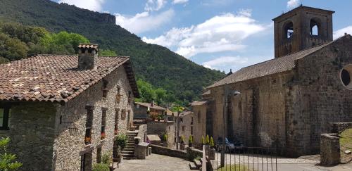 an old stone building with a tower and a church at 4LLARS in Beget