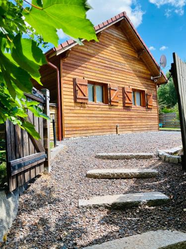 a house with a stone path in front of it at Le Hygge Chalet Gérardmer-Spa in Anould