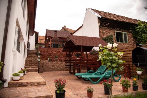 a patio with two lawn chairs and an umbrella at lclc in Dubova