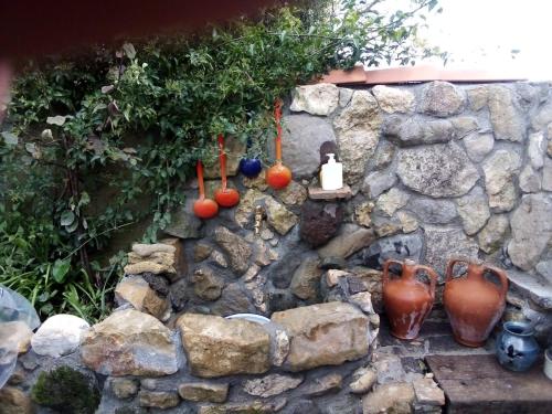 a stone wall with a bunch of vases on it at Belli come il Sole in Serri