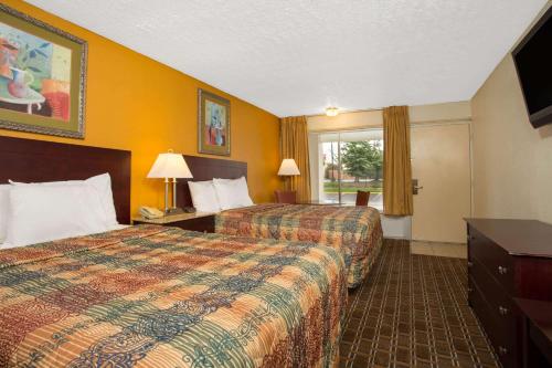 a hotel room with two beds and a window at Days Inn by Wyndham Chester in Chester