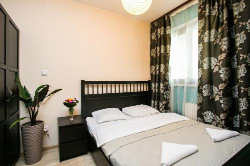 a bedroom with a bed and a window at Murano Apartaments in Warsaw