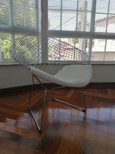 a white chair sitting in front of a window at PR Una Estrella Dorada in O Pedrouzo