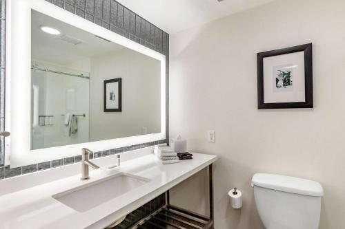 a white bathroom with a sink and a mirror at Cambria Hotel Downtown Phoenix in Phoenix