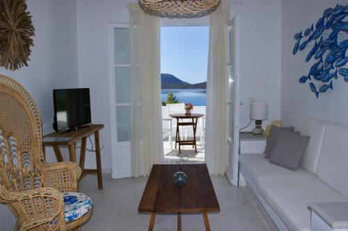 a living room with a couch and a table at Grand Bleu Apartments & Villas in Ermioni