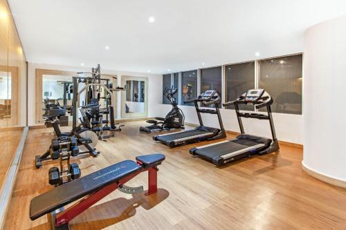 a gym with several treadmills and exercise bikes at La Quinta by Wyndham Medellin in Medellín