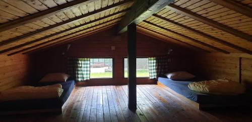 a room with two beds in the attic of a house at Camp Wild West in Höör