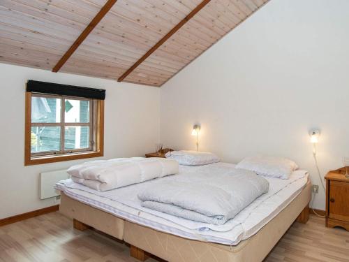 a bedroom with two beds with white sheets and a window at Three-Bedroom Holiday home in Hemmet 26 in Hemmet