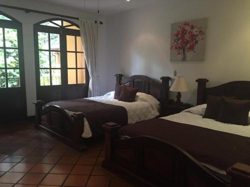 a bedroom with two beds and a window at Trapp Family Country Inn in San Antonio