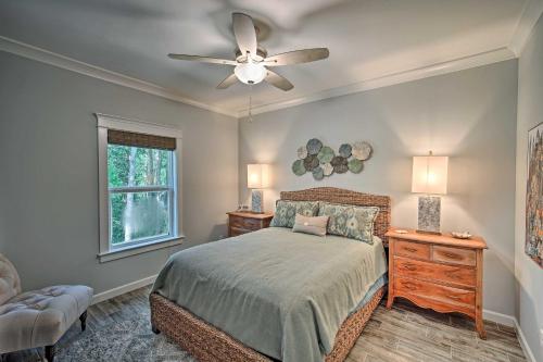 a bedroom with a bed and a ceiling fan at Quiet Fishermans House with Hot Tub and Tropical Bar! in Dauphin Island
