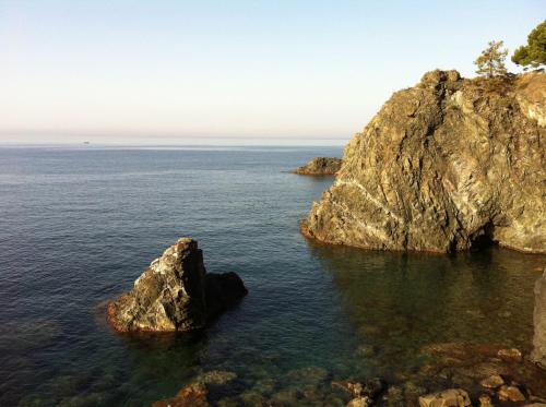 a large rock in the water next to the ocean at Dolcevia in Levanto