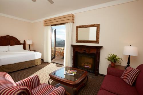 a hotel room with a bed and a fireplace at South Coast Winery Resort & Spa in Temecula