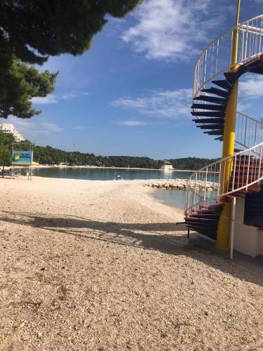 a staircase on a beach with the water at Villa Radić in Makarska
