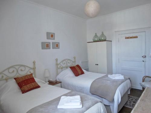 a bedroom with two beds and a table and a chair at Maison de Fortitude Chambres d'hotes in Salviac