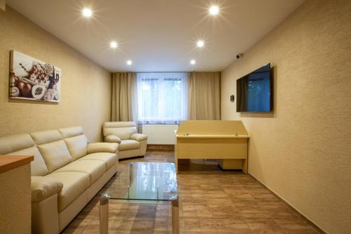 a living room with a couch and a table at Penzion Terezka in Hlučín