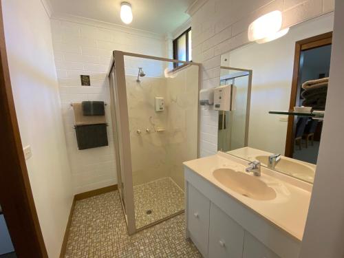 a bathroom with a sink and a shower at Orana Motor Inn in Mildura