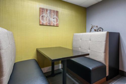 a room with a table and a bike on the wall at Holiday Inn Melbourne-Viera Conference Ctr by IHG in Melbourne
