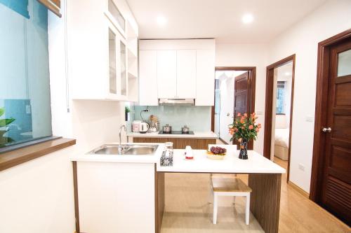 a kitchen with a sink and a counter top at Canary Ha Noi Hotel in Hanoi