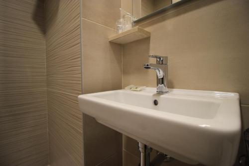 a bathroom with a white sink and a shower at Hostal Pensimar in El Altet