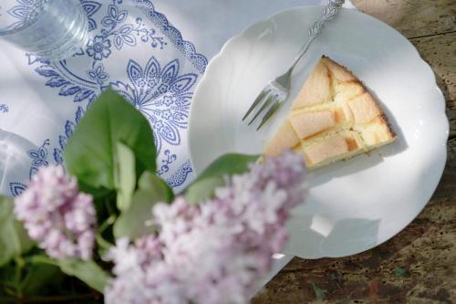 a piece of cake on a plate with a fork at Bauernhof Gschmeidler in Sankt Johann im Saggautal