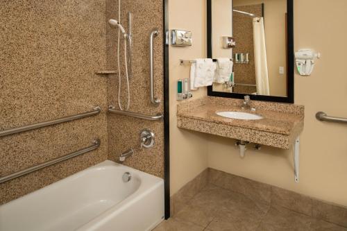 a bathroom with a tub and a sink at Best Western Kennewick Tri-Cities Center in Kennewick